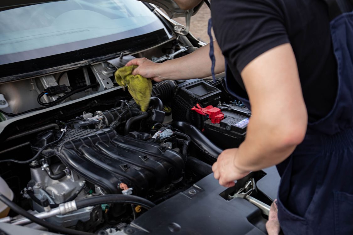 Mechanic servicing an engine bay